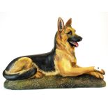 A large pottery figure of a German shepherd dog, L. 45cm . H. 37cm.