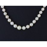 A necklace set with graduated cultured pearls with an 18ct diamond set clasp, L. 48cm.
