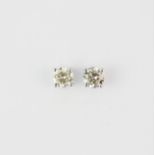 A pair of 18ct white gold solitaire stud earrings each set with a large brilliant cut diamond,