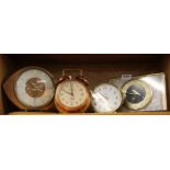 A group of four vintage clocks.