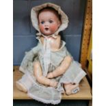 A large Armand Marseilles porcelain head and composition bodied baby doll, H. 52cm.