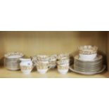 An extensive Edwardian Melba bone china tea set comprising of 11 cups, 12 saucers, 12 side plates, a