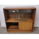 A 1960's teak cabinet with sliding glass and wood doors, W. 92cm. H. 84cm.