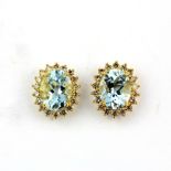 A pair of 18ct yellow gold stud earrings each set with a large oval cut aquamarine, approx. 3ct