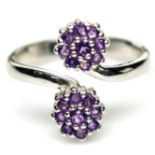 A 925 silver adjustable ring set with amethysts.