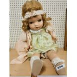 A vintage composition child doll by Horsman, with fluttering eyes and mamma cry, L. 57cm.
