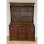 A large stained oak dresser, 153 x 218cm.