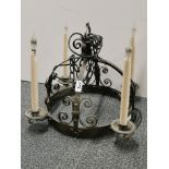 A baronial style wrought iron chandelier light fitting, H. 40cm. W. 40cm.