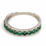 A 925 silver emerald set half eternity ring, (N).