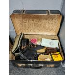 A vintage case and photographic items contents.