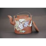 A mid-20th century Chinese hand enamelled terracotta teapot with metal handles, H. 13cm. Small