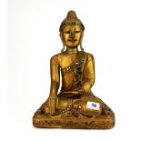 A Thai carved and gilt wooden figure of a seated Buddha, H. 36cm.