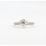An 18ct white gold solitaire ring set with a large brilliant cut diamond and diamond set