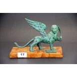 A patinated bronze figure of Venetian lion holding a sword on a marble base, L. 22cm. H. 16cm.