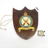 An oak Royal Air Force regiment wall plaque with a wrist rolling map patent no. 2431/24.