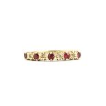 A hallmarked 9ct yellow gold ring set with round cut rubies and diamonds, (N.5).