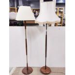 Two 1960's teak and brass standard lamps.