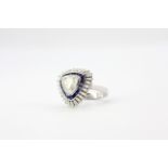 A large 18ct white gold ring set with a large trillion cut diamond, approx. 1.95ct, surrounded by