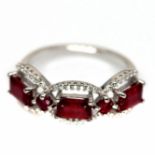 A 925 silver ring set with three baguette cut rubies and white stones, (O).