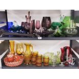 A large quantity of vintage coloured and clear glassware.