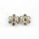 A pair of 14ct white gold daisy cluster stud earrings set with large brilliant cut diamonds, approx.
