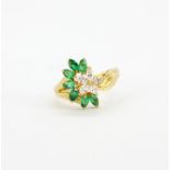 A 14ct yellow flower design ring set with marquise cut diamonds and marquise cut emeralds, (P).