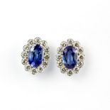 A pair of 18ct white gold cluster stud earrings each set with a large Sri Lanka sapphire, approx.
