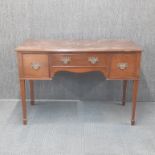 A early 20th century mahogany three drawer desk/side table with brass handles, 111 x 51 x 74cm.