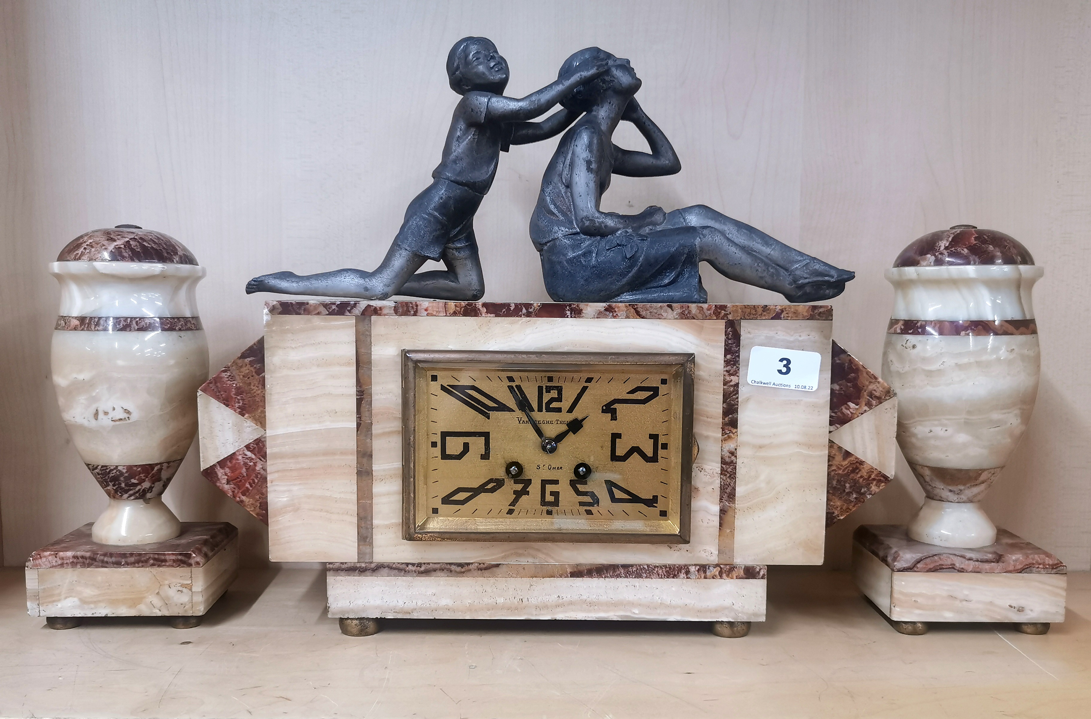 An Art Deco figural marble and spelter clock set, H. 34cm.