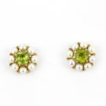 A pair of Edwardian 9ct yellow gold cluster stud earrings set with a round cut peridot surrounded by