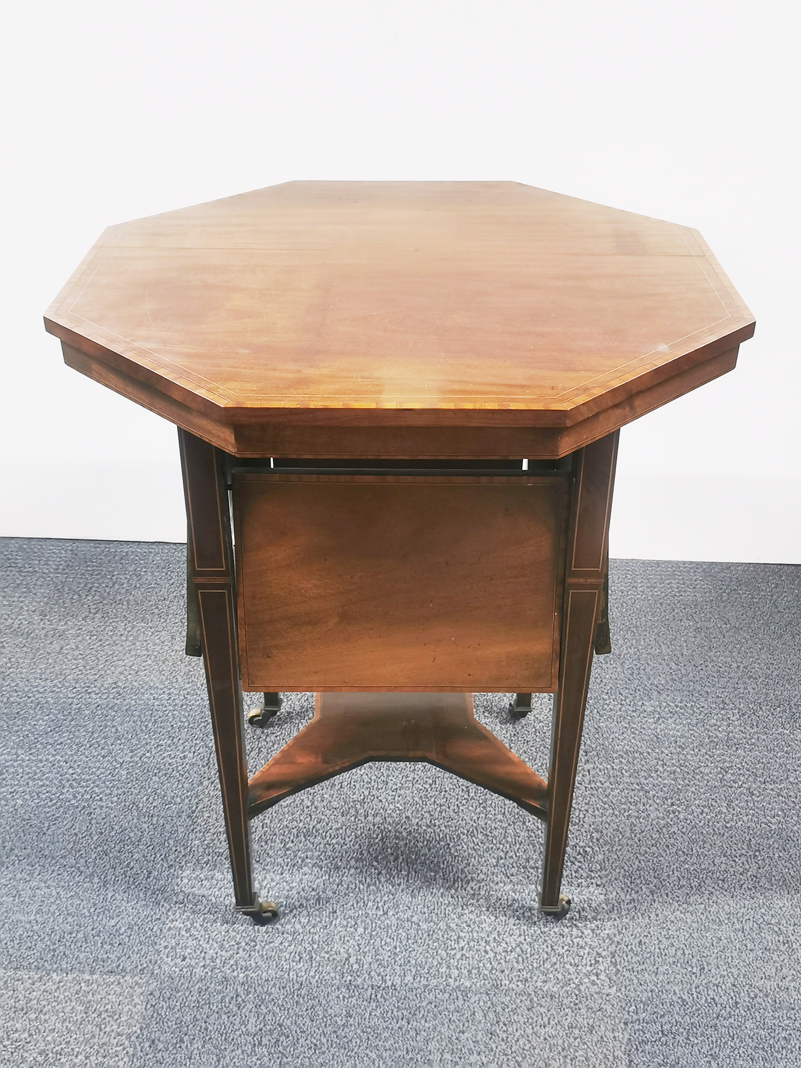 An Edwardian mahogany veneered and inlaid octagonal two-tier table with four interesting fold out - Image 3 of 3