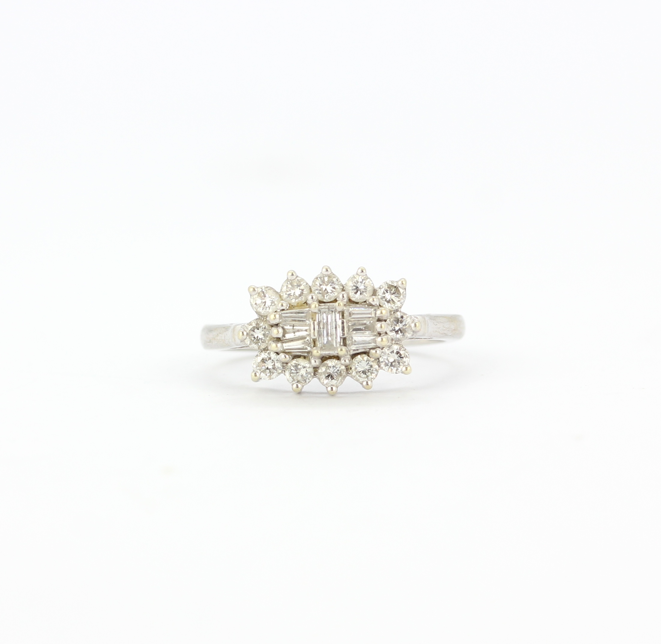 A hallmarked ring set with baguette and brilliant cut diamonds, (M).