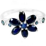 A 925 silver flower shaped ring set with oval cut sapphires, (O).
