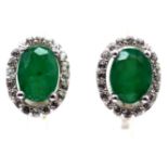 A pair of 925 silver earrings set with oval cut emeralds surrounded by white stones, L. 1cm.