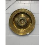 A large 18th century German hammered brass alms dish, Dia. 54cm. Prov. Estate of the late Dr.