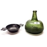 A Medieval green glass bottle, H. 16cm, together with an 18th century pewter porringer. Prov. Estate