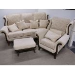 A heavy quality cream upholstered settee with a matching armchair and an Ercol footstool.