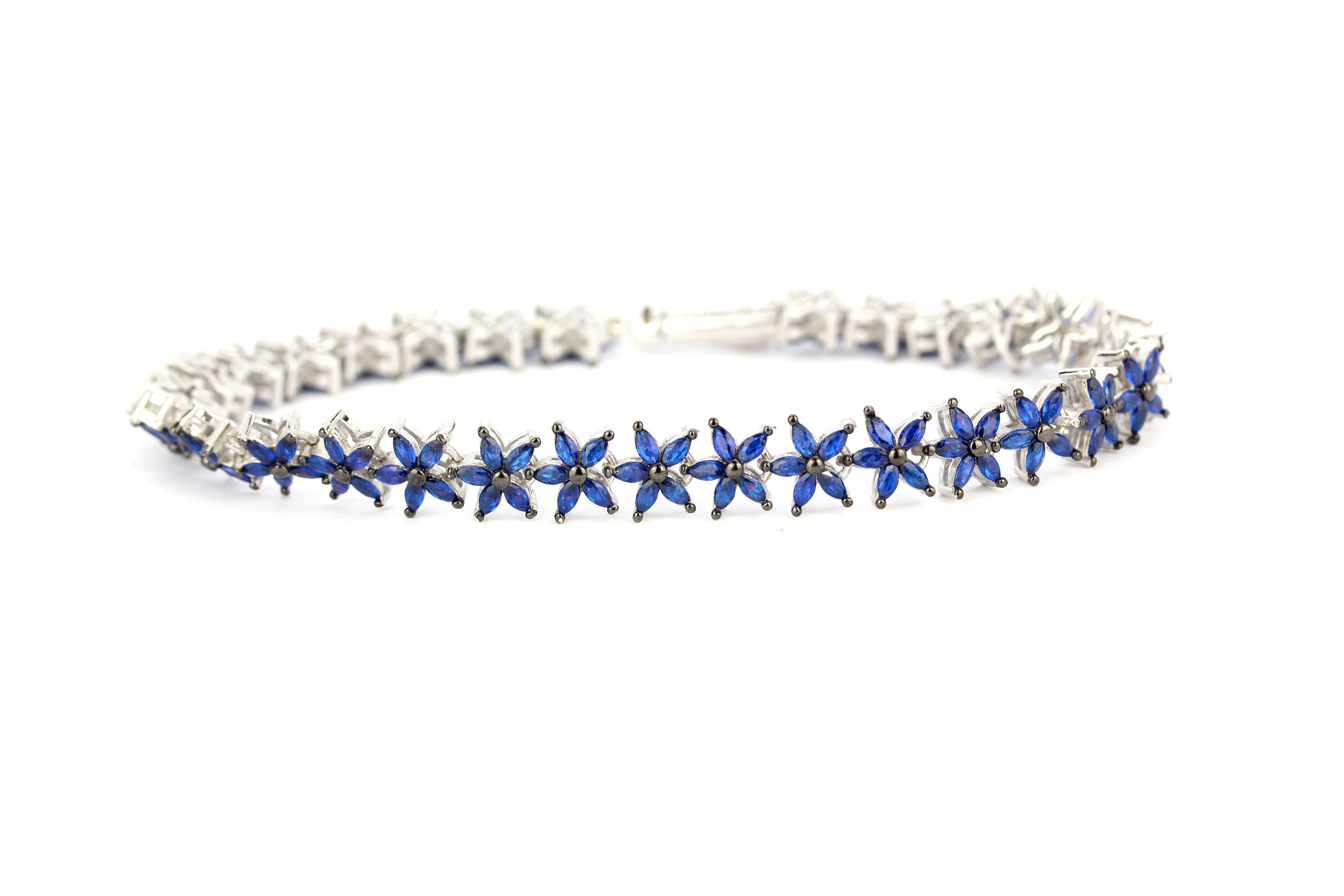 A 925 silver flower style tennis bracelet set with marquise cut sapphires, L. 19cm. - Image 2 of 3