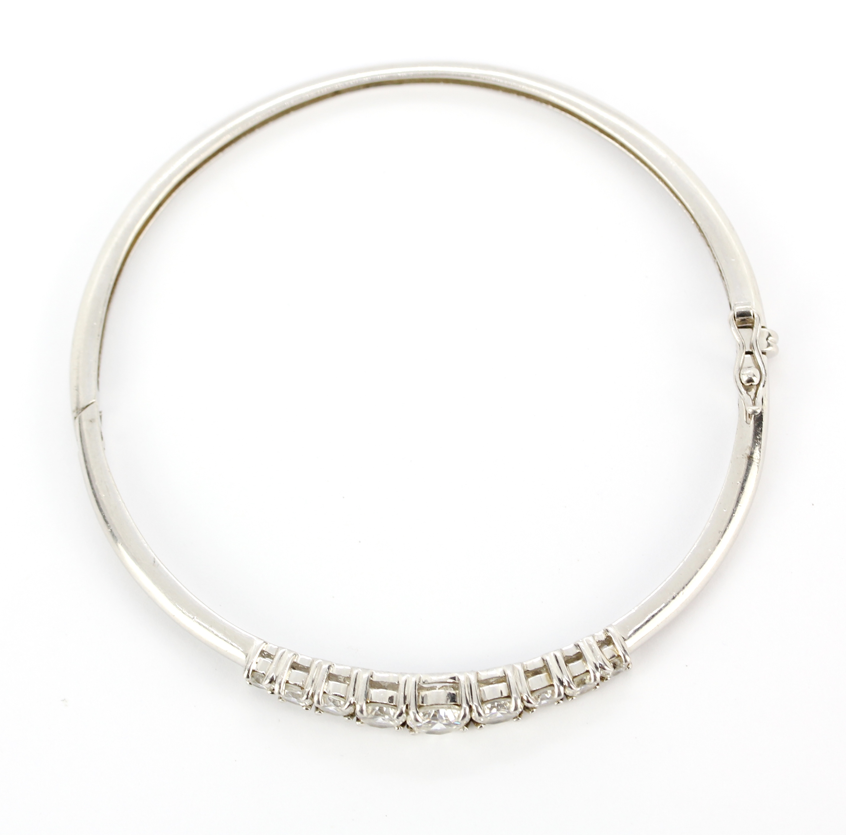 A 925 silver bangle set with graduated round cut cubic zirconias, dia. 6.5cm. - Image 2 of 2