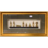 A cased set of Thai Buddhist figures, frame size 74 x 39cm.