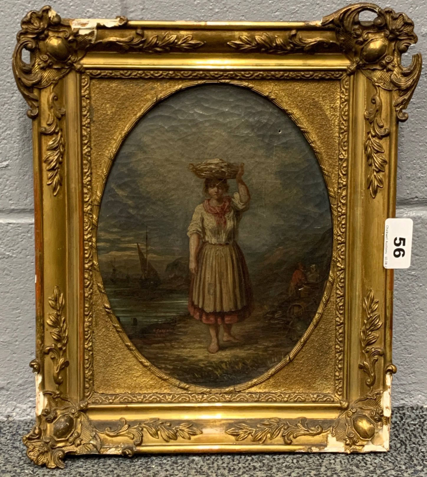 A gilt framed 19th century oil on canvas depicting a woman carrying a basket of fish on her head,