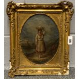 A gilt framed 19th century oil on canvas depicting a woman carrying a basket of fish on her head,