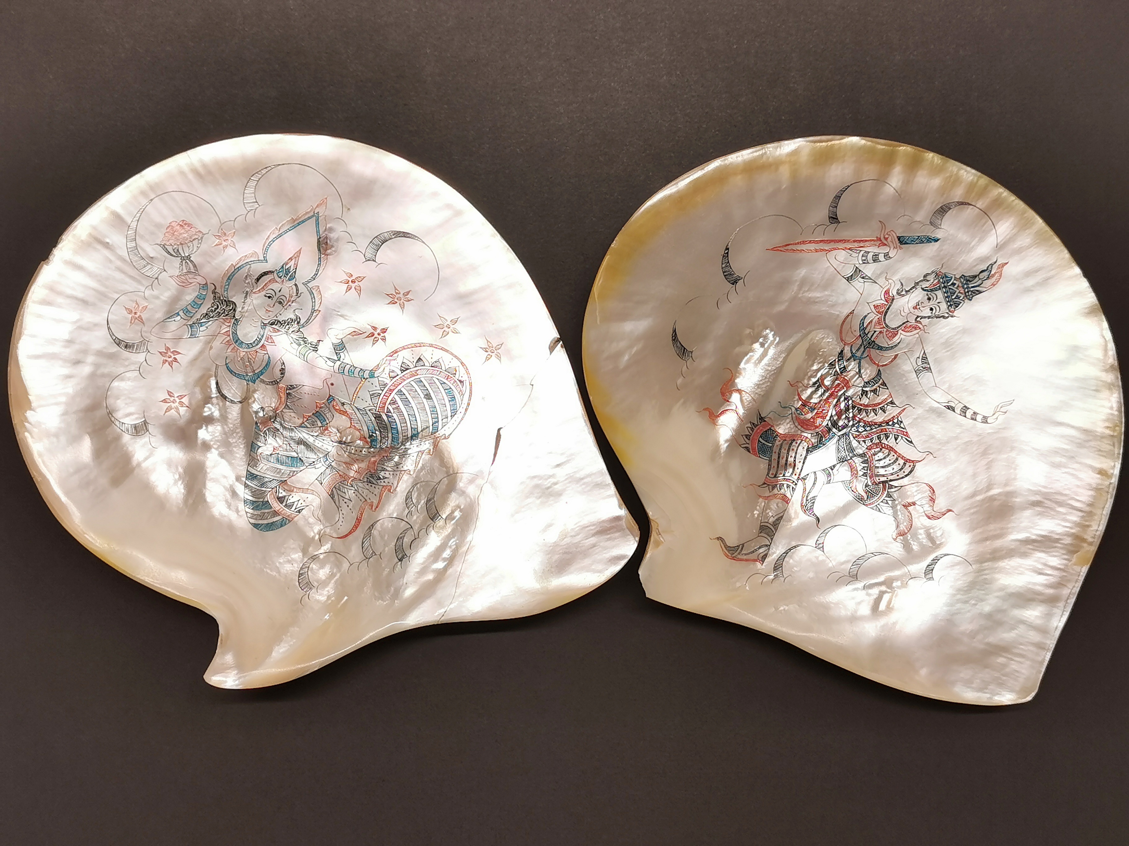 Two Thai engraved and inked freshwater muscle shells, W. 25cm. (one has repair).