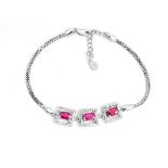 A 925 silver bracelet set with oval cut rubies and white stones, L. 19cm.