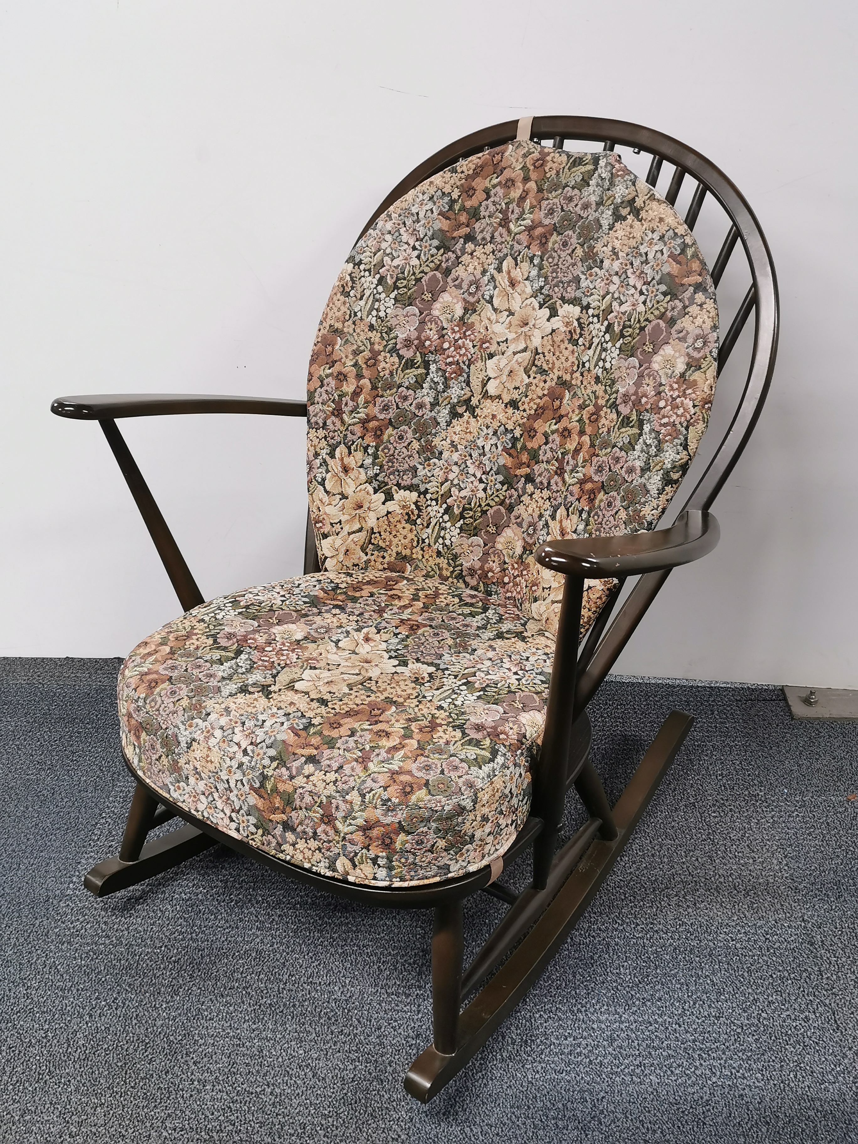 An Ercol style elm rocking chair, H. 95cm.