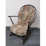 An Ercol style elm rocking chair, H. 95cm.
