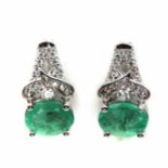 A pair of 925 silver drop earrings set with oval cut emerald and white stones, L. 1.6cm.