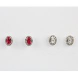 Two similar pairs of 925 silver cluster stud earrings set with cubic zirconia and one also set
