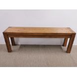 A heavy oak coffee table, 130 x 29 x 46cm.