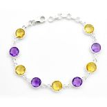 A 925 silver bracelet set with faceted amethysts and citrines, L. 19cm.